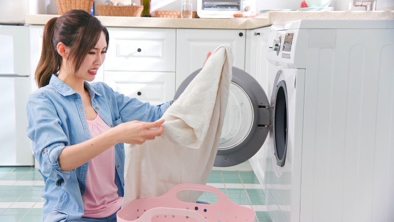 Women tired washing clothes Full view